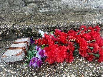 День партизан в Керчи: цветы придавили кирпичиком с лентой